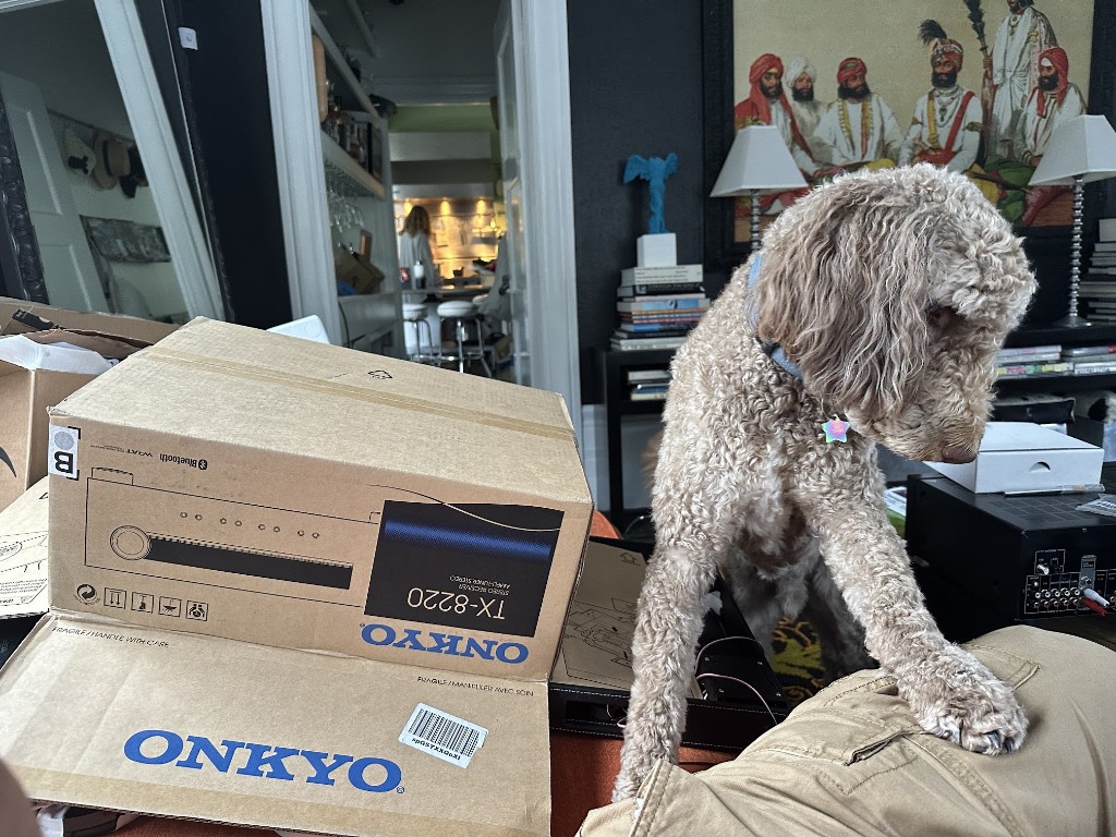 Home workspace with stereo receiver boxes and haptic prototype parts during assembly